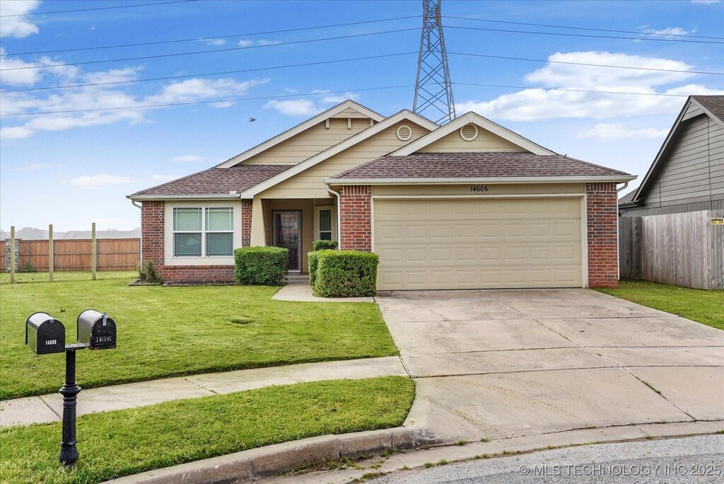 14606 109th Pl N, Owasso, OK 74055 - view of front of property with a front lawn, fence, a garage, and brick siding