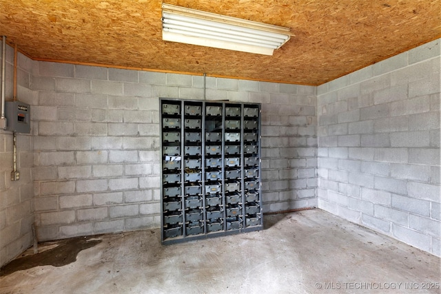 details featuring unfinished concrete floors and concrete block wall