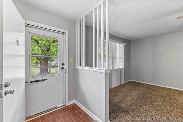 doorway to outside featuring baseboards