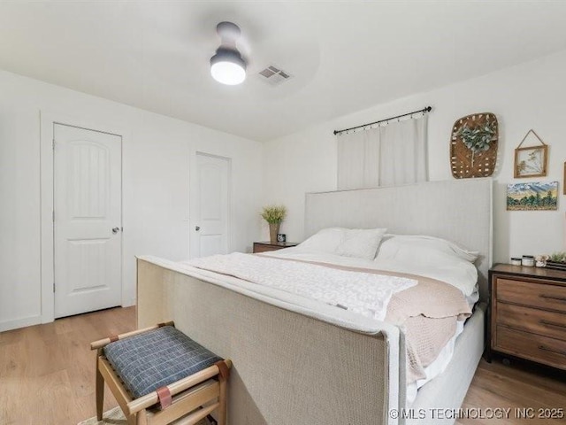 bedroom featuring visible vents and light wood-type flooring