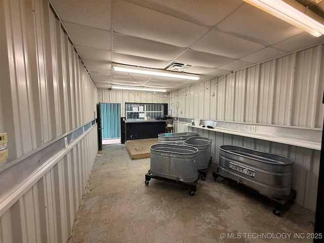 misc room with visible vents, concrete flooring, and a drop ceiling