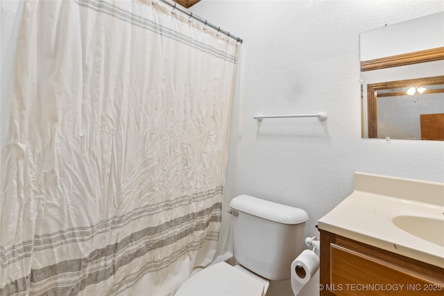 full bathroom with vanity, toilet, and a shower with curtain