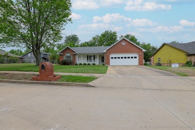 ranch-style house featuring a porch, a front lawn, a garage, driveway, and brick siding