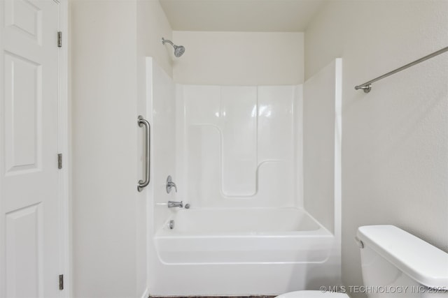 bathroom featuring washtub / shower combination and toilet