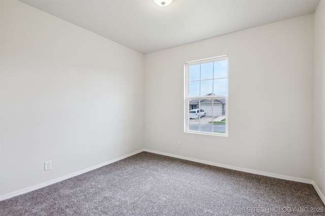 carpeted spare room with baseboards