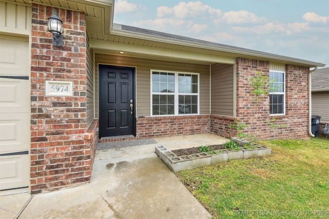 5974 E 146th Pl S, Bixby, OK 74008 - entrance to property featuring brick siding, a porch, a lawn, and an attached garage