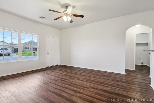 5974 E 146th Pl S, Bixby, OK 74008 - unfurnished room with arched walkways, a ceiling fan, dark wood-type flooring, and baseboards