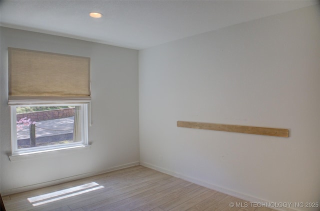 unfurnished room featuring baseboards, recessed lighting, and light wood finished floors