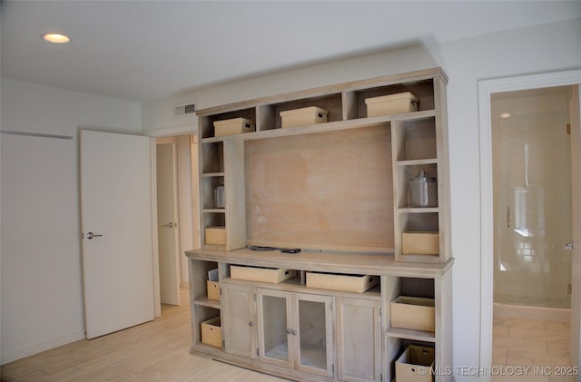 interior space with baseboards, visible vents, light wood finished floors, and recessed lighting