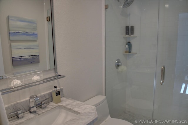 bathroom featuring a sink, decorative backsplash, toilet, a stall shower, and a textured wall