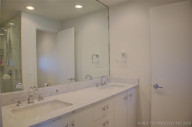 bathroom featuring recessed lighting, a stall shower, and a sink