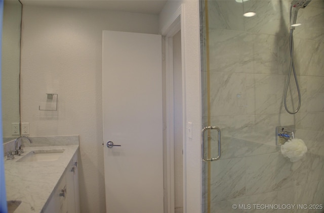 bathroom featuring a stall shower and vanity
