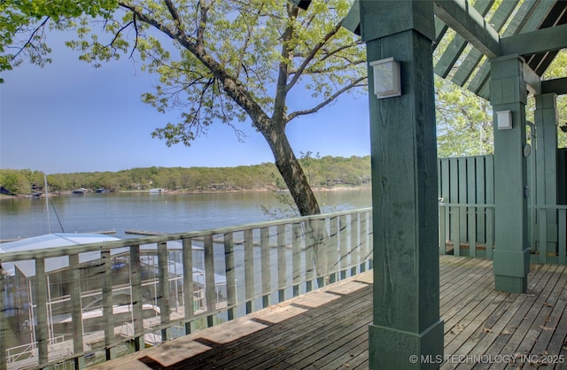 wooden terrace featuring a water view