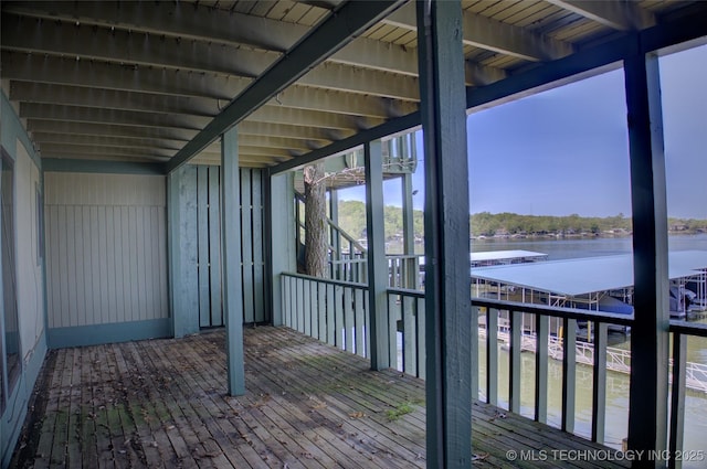 wooden terrace featuring a water view