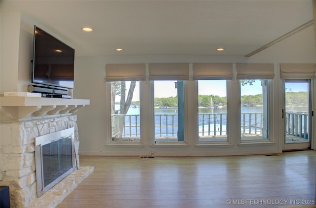 unfurnished living room featuring a fireplace, hardwood / wood-style flooring, and recessed lighting