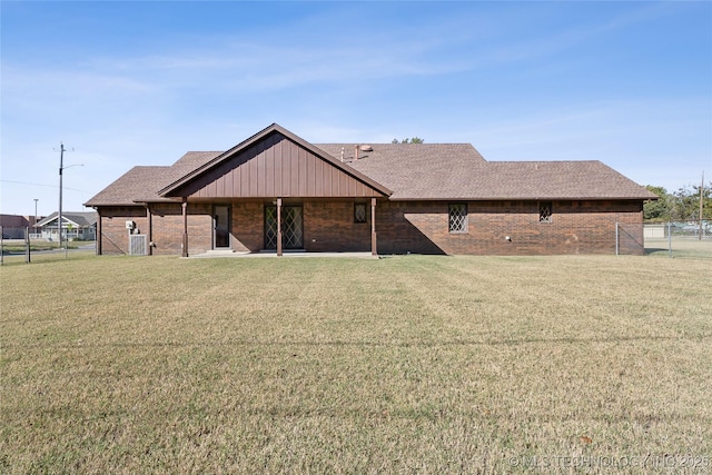 601 N Okmulgee Ave, Okmulgee, OK 74447 - rear view of house with brick siding and a lawn