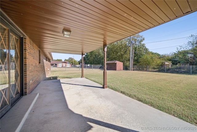 601 N Okmulgee Ave, Okmulgee, OK 74447 - view of patio / terrace featuring fence and an outbuilding