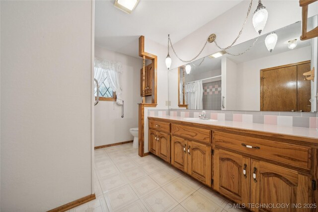 601 N Okmulgee Ave, Okmulgee, OK 74447 - full bathroom featuring tile patterned floors, a shower with shower curtain, toilet, vanity, and baseboards
