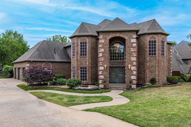 french provincial home featuring brick siding, a front lawn, roof with shingles, and french doors
