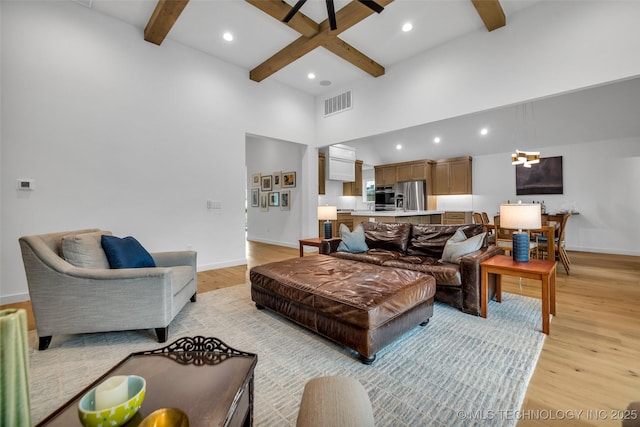 11529 S Marion Ave, Tulsa, OK 74137 - living room featuring light wood finished floors, beam ceiling, baseboards, recessed lighting, and a high ceiling