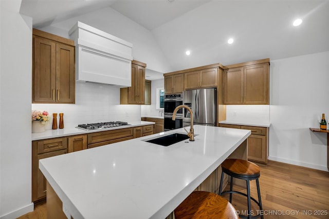 11529 S Marion Ave, Tulsa, OK 74137 - kitchen with stainless steel appliances, vaulted ceiling, backsplash, a center island with sink, and a sink