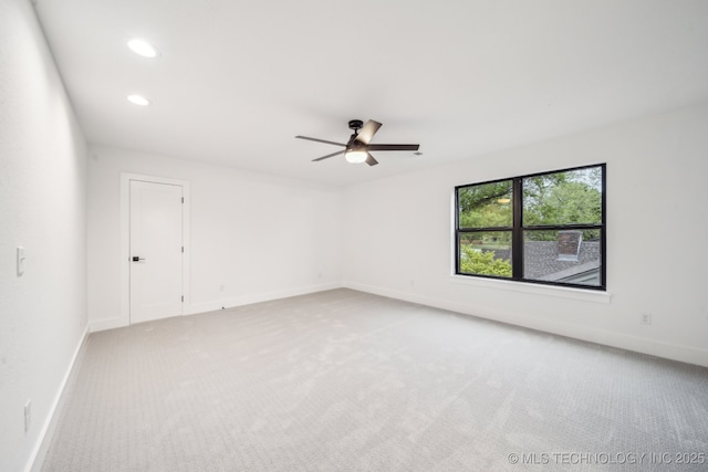 spare room with light colored carpet, a ceiling fan, recessed lighting, and baseboards