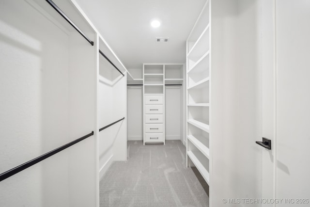 spacious closet with visible vents and light colored carpet