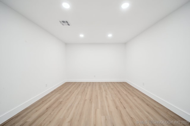 unfurnished room with recessed lighting, light wood-style flooring, and baseboards