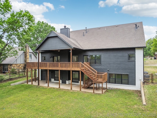 rear view of property with a chimney, a yard, stairway, a patio, and a wooden deck