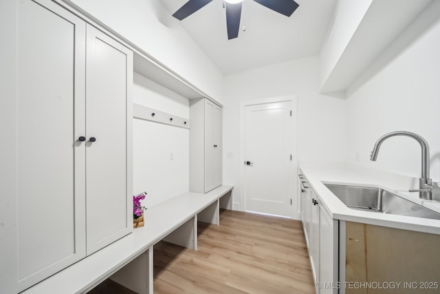 mudroom with a ceiling fan, a sink, and light wood-style flooring