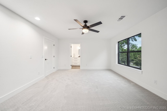unfurnished bedroom with baseboards, visible vents, light colored carpet, and recessed lighting
