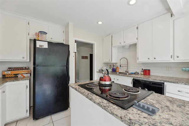 kitchen with black appliances, a sink, white cabinets, and decorative backsplash
