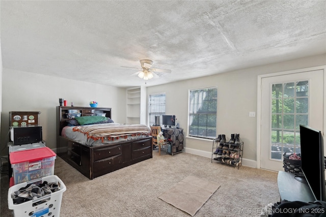 bedroom with a textured ceiling, carpet flooring, ceiling fan, and baseboards