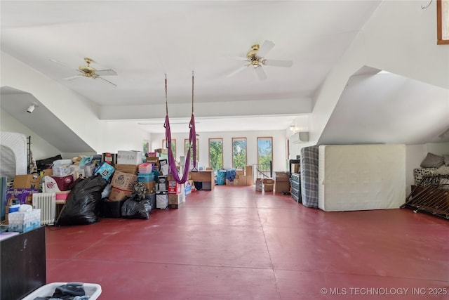 bonus room with ceiling fan and concrete flooring