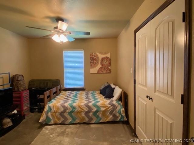 bedroom featuring ceiling fan and a closet