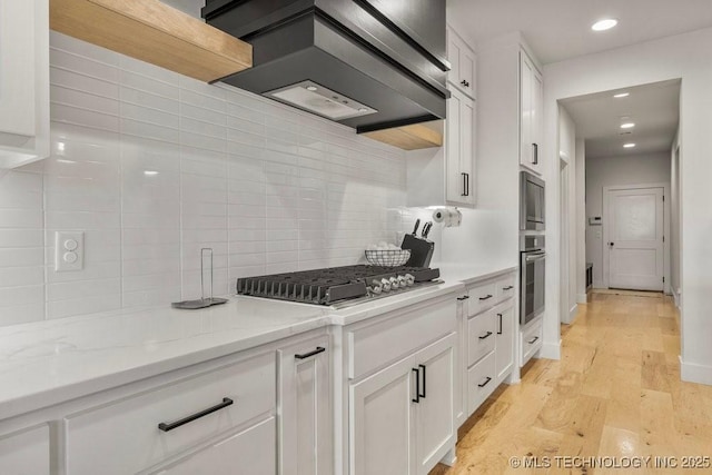 13722 S 20th Pl E, Bixby, OK 74008 - kitchen with premium range hood, white cabinets, stainless steel gas stovetop, and backsplash
