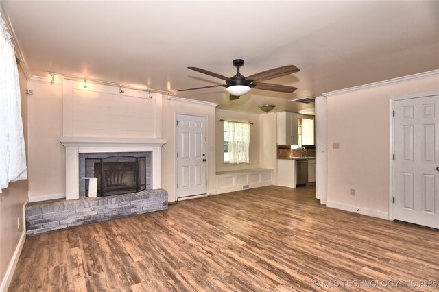 705 W Boston St, Broken Arrow, OK 74012 - unfurnished living room featuring crown molding, ceiling fan, wood finished floors, and baseboards