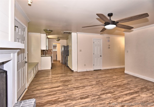 705 W Boston St, Broken Arrow, OK 74012 - unfurnished living room featuring a sink, visible vents, ceiling fan, baseboards, and wood finished floors