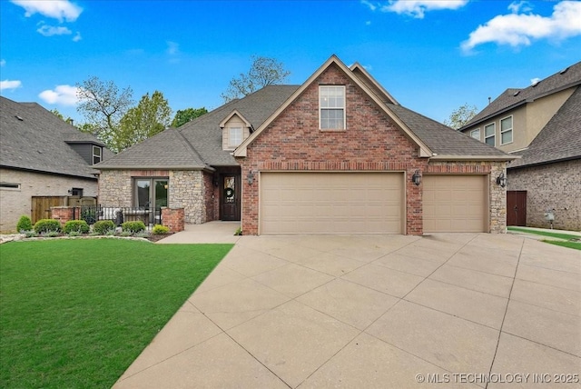 view of front of property with concrete driveway, roof with shingles, a front yard, and brick siding