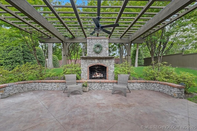 view of patio featuring an outdoor stone fireplace, fence, and a pergola