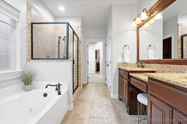 bathroom featuring a stall shower, tile patterned flooring, a whirlpool tub, and vanity