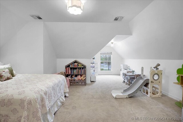 bedroom with visible vents, vaulted ceiling, and carpet floors