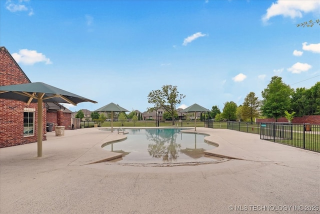 view of swimming pool featuring a patio, fence, and a fenced in pool