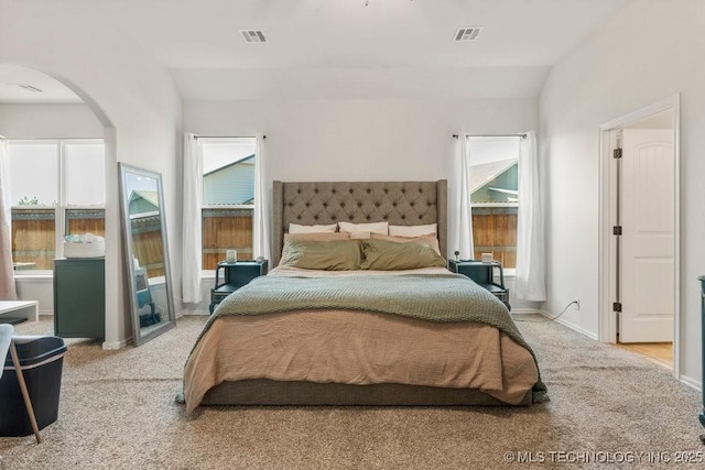 7305 S Walnut Ave, Broken Arrow, OK 74011 - bedroom with arched walkways, light carpet, and baseboards