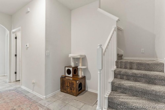 7305 S Walnut Ave, Broken Arrow, OK 74011 - stairway featuring tile patterned flooring, baseboards, and arched walkways
