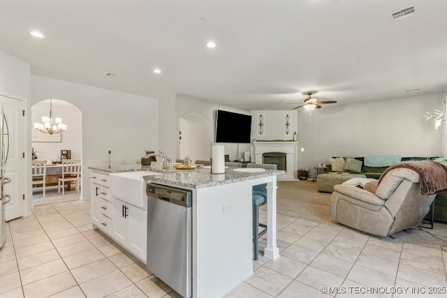 7305 S Walnut Ave, Broken Arrow, OK 74011 - kitchen with dishwasher, a ceiling fan, arched walkways, white cabinets, and light tile patterned floors