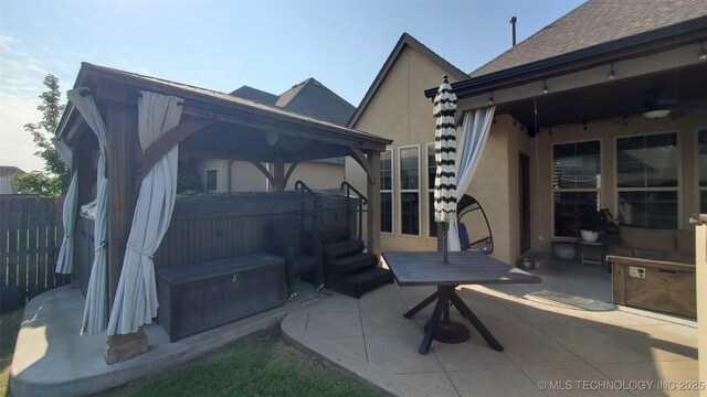 16321 E 48th Pl, Tulsa, OK 74134 - view of patio / terrace with a jacuzzi, a gazebo, and fence