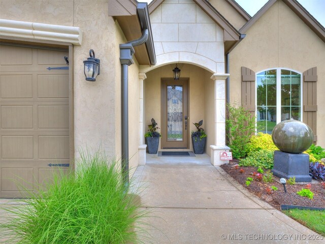 16321 E 48th Pl, Tulsa, OK 74134 - doorway to property with a garage and stucco siding