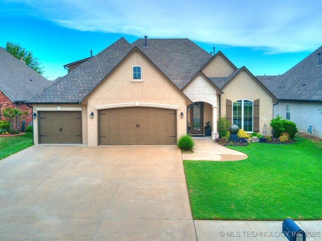 16321 E 48th Pl, Tulsa, OK 74134 - view of front facade with stucco siding, a garage, roof with shingles, a front yard, and concrete driveway