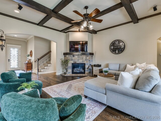 16321 E 48th Pl, Tulsa, OK 74134 - living room featuring arched walkways, wood finished floors, coffered ceiling, ceiling fan, and a stone fireplace